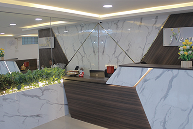 Reception desk and patient waiting area inside Niveena Homeo Clinic in Chennai